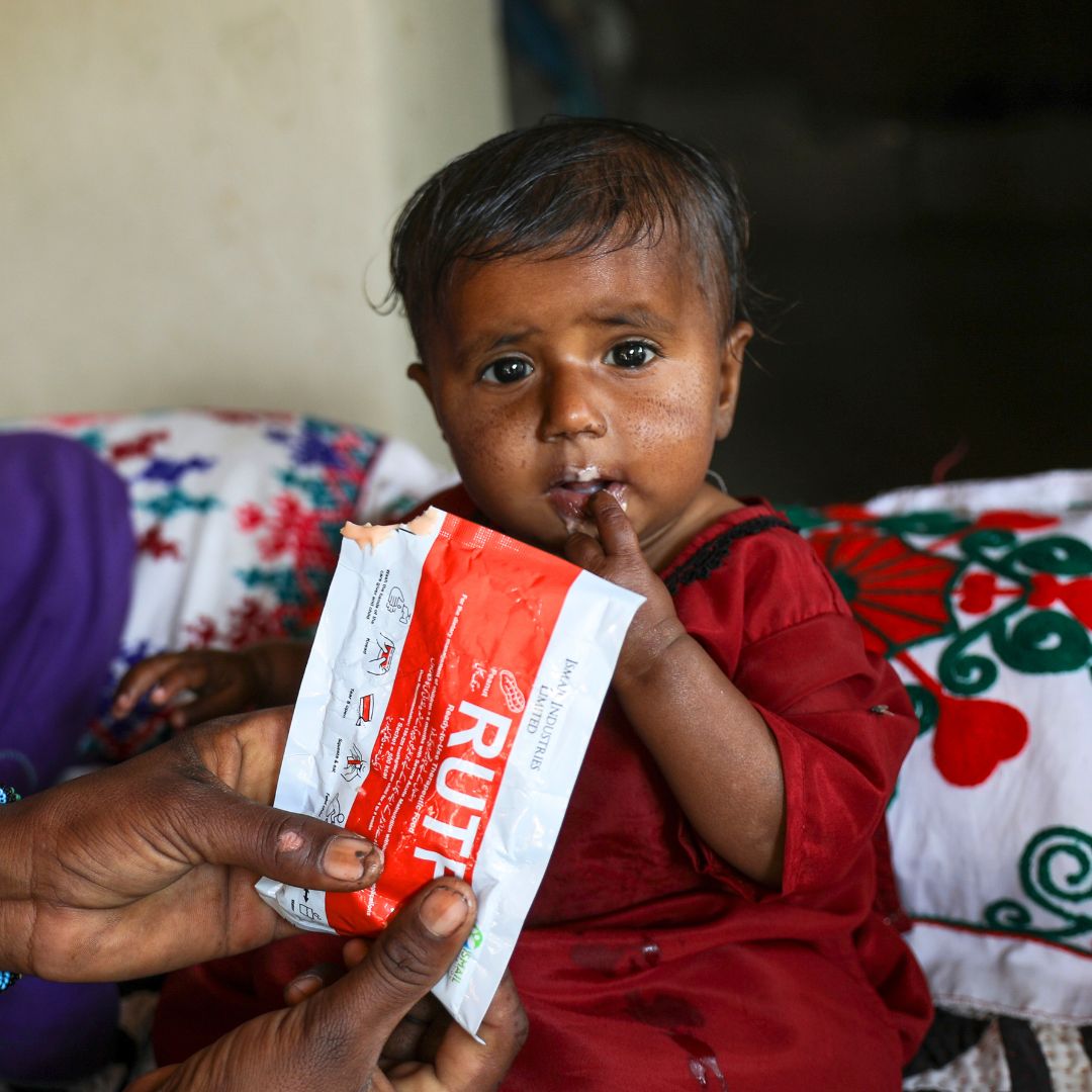 Farzana feeds her daughter ready-to-use therapeutic food (RUTF)